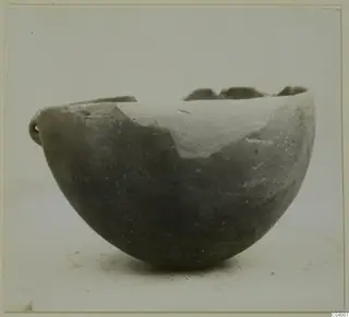 Red Polished III bowl from Lapithos, with a small handle and a broken rim