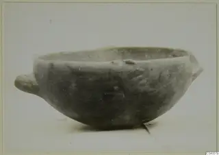 Pottery Red Polished III bowl with a small handle on each side, shown in side view