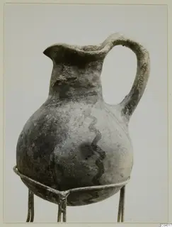 White Painted III-2 jug from Lapithos with a dark wavy line painted down its body