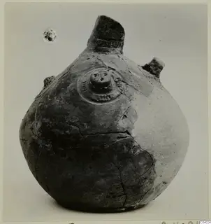 Pottery Red Polished III Amphora from Lapithos, with a tall broken neck, side lugs and a central boss on the shoulder