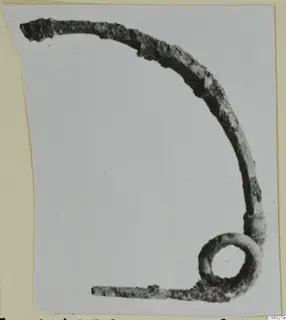 Bronze personal adornment with a curved arm and a loop at one end, from the Kastros tombs at Lapithos