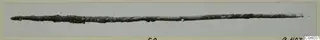 Corroded metal rod from Idalion, lying horizontally across a pale grey background