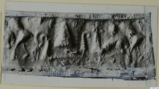 Impression of a rectangular seal with worn figures in low relief, mounted on a card