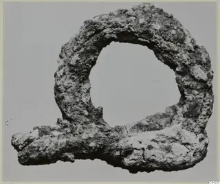 Corroded metal loop fragment with a projecting bar, from Idalion