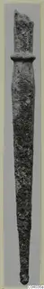 Bronze weapon: a long, corroded metal blade with a raised collar near the top.