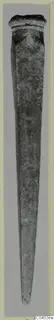 Long tapering bronze object with a raised rim at its upper end, shown upright against a grey mount