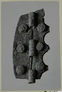 Corroded metal hinge-like fitting with three knuckles and six rivet heads, Idalion bronze and metalwork