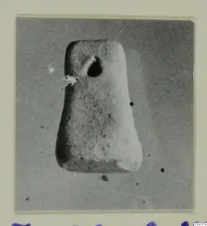Tapered object with a hole near its top, photographed on a mount, from Idalion