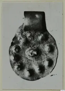 Round pendant with a rectangular loop at the top, from Idalion