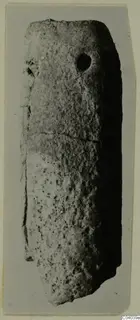 Elongated stone pendant with a hole near its upper end, from Idalion.