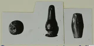 Three small dark objects shown side by side on a mounted photograph card