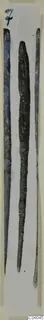 Three long, narrow bronze tools laid side by side on a white card.