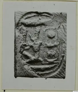 Rectangular seal with raised curved, angular and round motifs