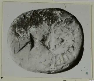 Glyptic: oval stone seal from Idalion with a worn engraved design