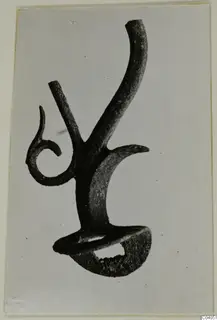 Bronze mounting fragment from Idalion with a curled spiral arm and a tall curved arm
