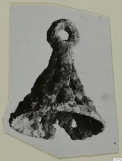 Bronze horse-trapping with a loop at the top and a triangular lower part with two holes.
