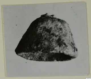 Heavily corroded bronze object, recorded as horse-trappings from Idalion, photographed on a card mount.