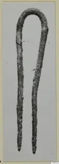 Bronze personal adornment from Idalion: a corroded metal pin bent into a loop with two tapering prongs