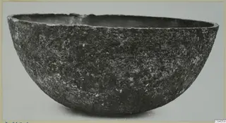 Deep, rounded bowl with a rough, encrusted surface, from the Kastros tombs at Lapithos, seen from the side
