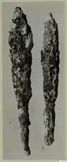 Two corroded iron weapons, long pointed blades shown side by side