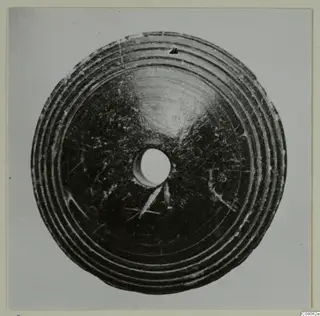 Disc-shaped small find with concentric ridges and a central hole, from Idalion