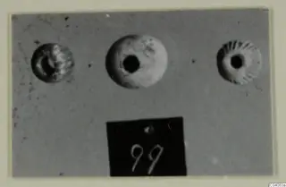 Three small round jewellery objects with central holes, from Enkomi Tomb 6