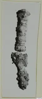 Two corroded metal fragments, one cylindrical and ridged, the other irregular, from Enkomi Tomb 8