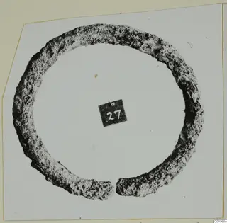 Corroded metal ring with an open gap, from Enkomi Tomb 18