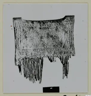 Bone object from Enkomi with incised bands and a central panel, and long narrow teeth along its lower edge