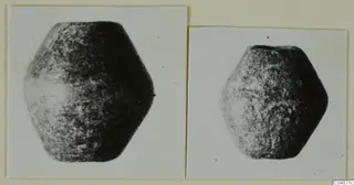 Two photographs on a card of a small, dark, rounded object with flat faces, one larger than the other