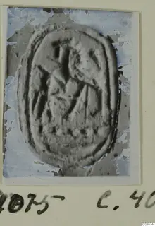 Carved oval seal or gem shown in a photograph mounted on a card