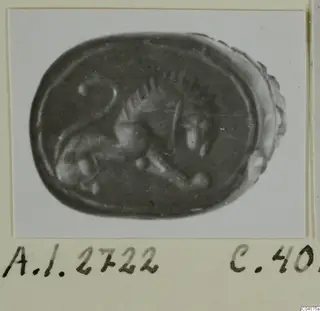 Oval seal with an engraved animal in profile, photographed on a card mount