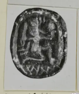 Oval stone seal, scarab-shaped, with an incised design on its flat base, shown on a mounted card.