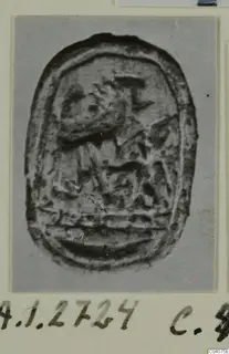 Oval seal-gem from Ayia Irini with a carved design, photographed on a card mount