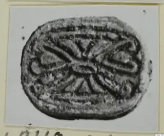 Engraved seal from Ayia Irini, oval in outline, with a symmetrical pattern of curved and radiating lines