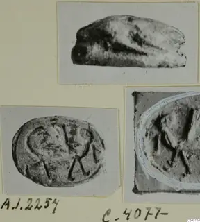 Three photographs on a card of a small stone scarab seal: a side view and two views of its engraved base