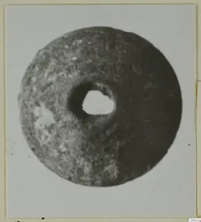 Disc-shaped find with a round central hole, from Ayia Irini