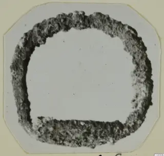 Ring from Marion: a thick, dark, rough-edged ring shape in a photograph mounted on a card
