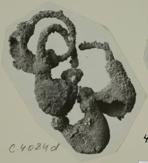 Corroded metal rings from Marion, encrusted and clumped together in a single mass