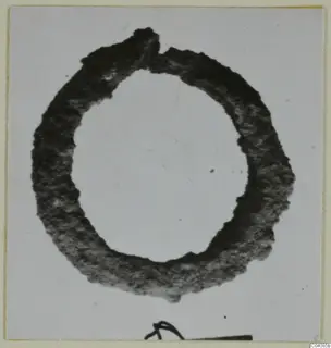Ring-shaped silver object, dark and tarnished, shown alone against a pale grey background