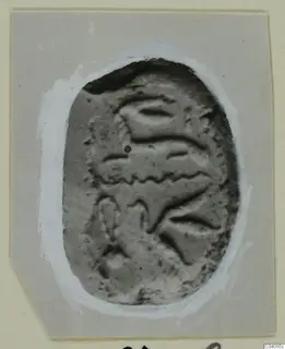 Oval plaque from Marion with a raised pattern of curved bands and a small hole near the upper left.