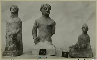 Three figures and sculptures from Marion, photographed on a plain pale backdrop