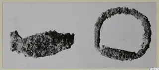 Two corroded silver objects from Marion: an elongated fragment and a ring, shown on a pale background.