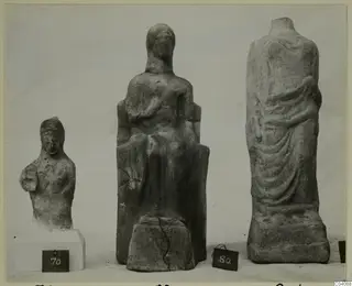 Three sculptures from Marion on a plain background, one seated, with dark number labels in front.