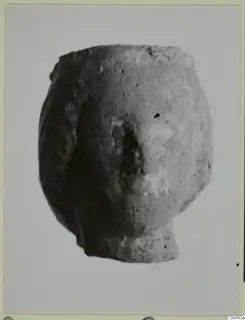 Terracotta fragment of a small figure from Soli, photographed against a plain background.