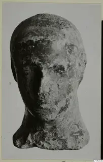 Terracotta head of a small figure, worn, seen from the front