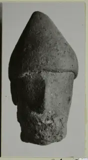Small terracotta figurine with a tall conical top and cylindrical body, with a projecting form on one side