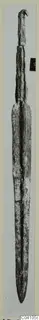 Long bronze blade with a tang, from Ayios Iakovos Tomb 14, photographed upright against a pale background