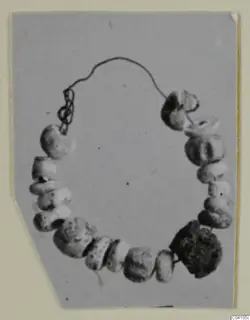 String of beads on a fine wire, arranged in a loose ring, from Ayios Iakovos Tomb 14