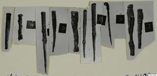 Ten metal tools and pins from Nitovikla T.I, each mounted on its own grey card strip.